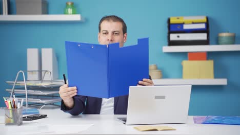 Cheerful-businessman-working-on-files.